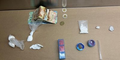 OPP display suspected hydromorphone pills and other items seized during a traffic stop in Orillia.