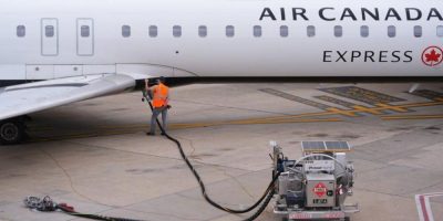 A worker fuels an Air Canada jet at Dallas Fort Worth International Airport in Grapevine, Texas, on April 14, 2026.