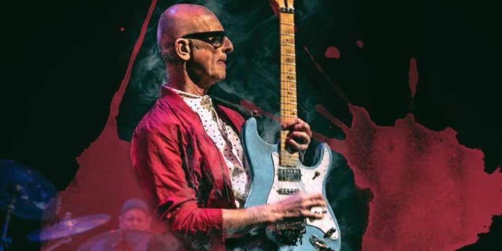 Canadian rocker Kim Mitchell performing live on stage during a concert appearance.