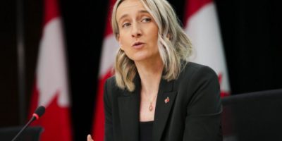 Dr. Joss Reimer, Canada’s Chief Public Health Officer, speaks at a podium during a press conference in Ottawa, providing updates on infectious disease response and public health measures.