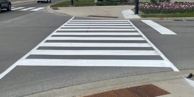 Road crew repainting lane markings and arrows on a Barrie street during overnight maintenance work