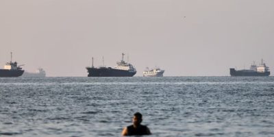Cargo and commercial vessels anchored in the Strait of Hormuz off Bandar Abbas, Iran, after the U.S. and Iran reached an agreement to reopen the strategic waterway and resume nuclear negotiations.