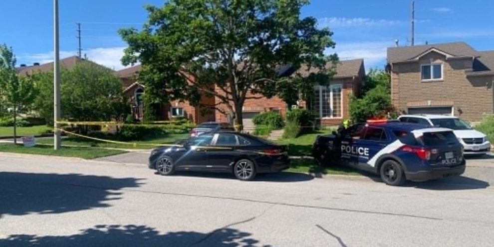 Police vehicles and crime scene tape outside a home near St. Vincent Street and Osprey Ridge Road in Barrie where a man and woman were found dead during a well-being check on June 20, 2026.