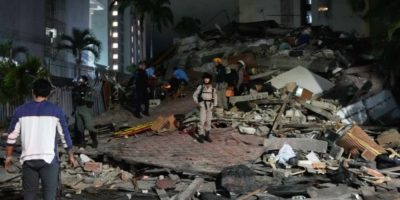 Rescue workers search through the rubble of collapsed buildings in Caracas after powerful earthquakes struck Venezuela, killing dozens and injuring hundreds.