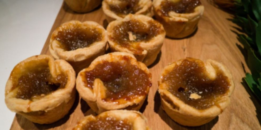 Assorted butter tarts on a serving tray.