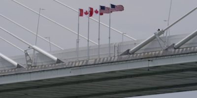 Canadian and American flags hang on the Gordie Howe International Bridge spanning the Detroit River between Windsor, Ontario, and Detroit, Michigan, in May 2026. File photo.