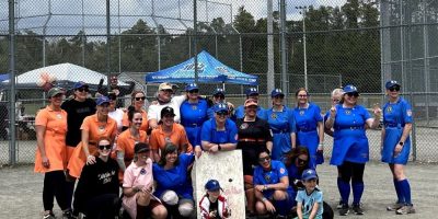 Women wearing dresses play slow-pitch baseball during a previous Dirt in the Skirt tournament in the Barrie area. File photo.
