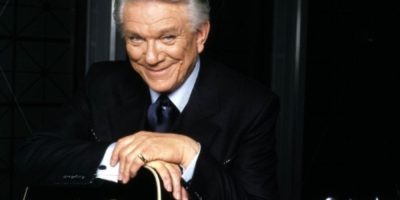 Tommy Hunter holding a guitar in an undated photo. The Canadian country music legend and CBC television host has died at age 89.