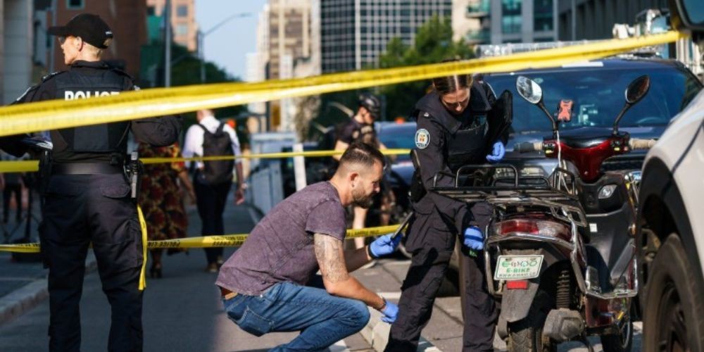 Toronto Police officers at scene where officer was shot responding to e-bike robbery