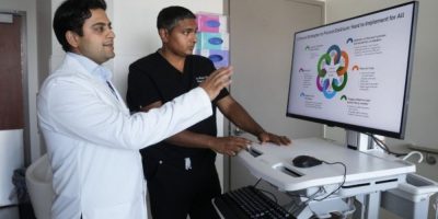 Dr. Amol Verma (left) speaks while Dr. Fahad Razak looks on at St. Michael's Hospital in Toronto, where researchers are testing an AI tool to help identify hospital patients at risk of delirium.