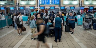 Travellers wait at the check-in area for cancelled WestJet flights at Vancouver International Airport