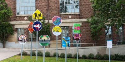 Recalculating public sculpture featuring street sign designs created by Barrie youth