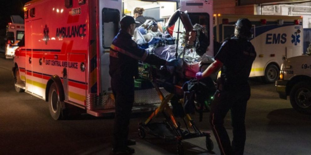 Paramedics load an injured person into an ambulance at Wainwright Health Centre after a fire at CFB Wainwright in Alberta on Oct. 17, 2026.